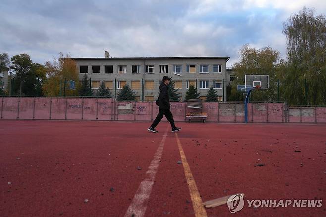 포격에 부서진 학교 앞을 지나는 하르키우주 15세 청소년 보흐단  [AFP 연합뉴스. 재판매 및 DB 금지]