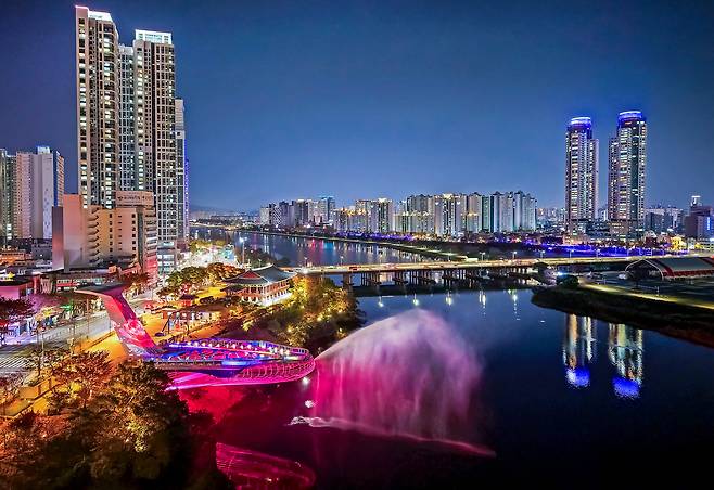 울산 도심의 태화강을 배경으로 영남 3루 중 하나인 태화루 옆에 들어선 하늘 산책길 ‘태화루(용금소) 스카이워크’ 야경. 울산의 상징인 ‘고래’ 형상으로 물을 내뿜고 있는 모습이 태화강 주위 야경과 어우러져 환상적인 풍경을 연출하고 있다. [울산시 제공]