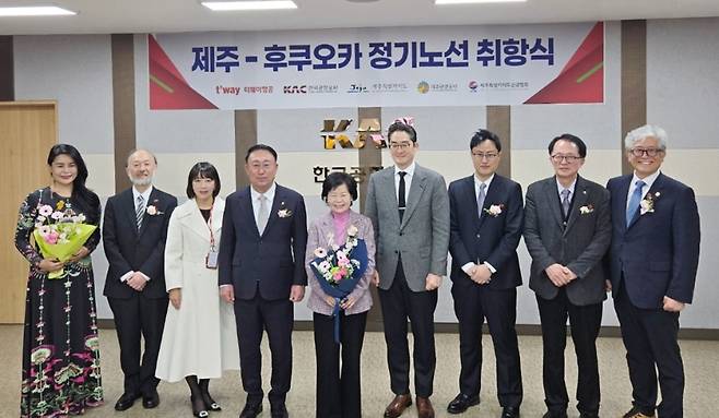 티웨이항공 제주~후쿠오카 정기노선 취항식이 19일 제주국제공항에서 열렸다. 제주도청과 공항 당국, 항공사 관계자들이 기념촬영을 하고 있다. (티웨이항공 제공)