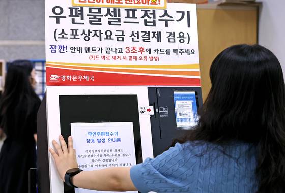 지난 9월 29일 오전 서울 종로구 광화문우체국에서 직원이 무인우편접수기에 국가정보자원관리원 화재로 인한 장애 발생 안내문을 붙이고 있다. 뉴스1