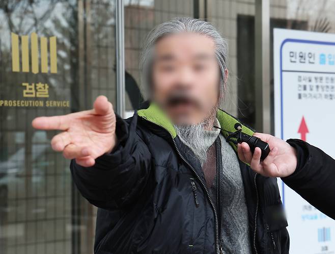 Cho Doo-soon, a convicted child sex offender, answers reporters' questions at the Ansan branch of the Suwon District Court in Ansan, Gyeonggi, on March 11, 2024. [YONHAP]