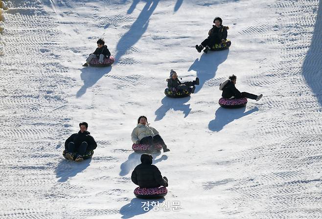 성탄절인 25일 서울 노원구 서울과학기술대학교 종합운동장에 마련된 ‘노원 씽씽 눈썰매장’을 찾은 어린이들과 시민들이 눈썰매를 타고 있다.