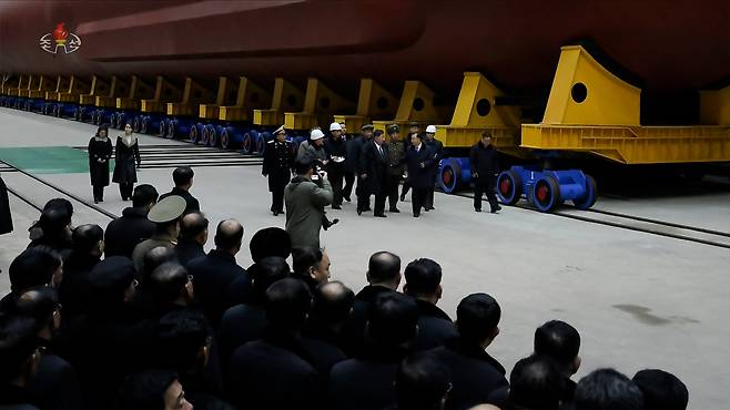 North Korean leader Kim Jong-un inspects the building site for a 8,700-ton nuclear-powered strategic guided missile submarine in this photo released by the Korean Central News Agency on Dec. 25. [KOREAN CENTRAL NEWS AGENCY]