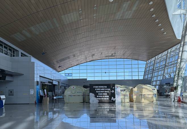 Dozens of yellow emergency tents are installed on a departure floor at Muan International Airport in South Jeolla on Dec. 22. [LEE SOO-JUNG]
