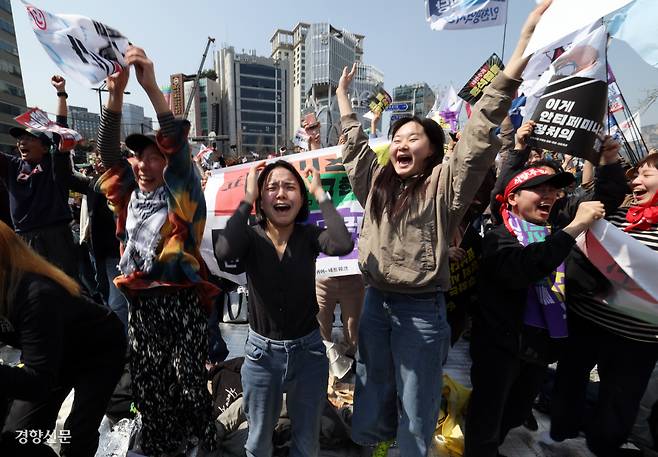 “윤석열을 파면한다” “주문, 피청구인 대통령 윤석열을 파면한다.” 문형배 헌법재판소장 권한대행이 결정문을 읽었다. 헌법재판소 재판관 전원일치 의견으로 윤석열 대통령을 파면한 4월4일 헌법재판소 인근에서 열린 대통령 파면 촉구 집회에 참석한 시민들이 일제히 자리에서 일어나 환호하고 있다. 올해 가장 긴장한 순간이면서 동시에 후련했던 순간이다.  서성일 선임기자
