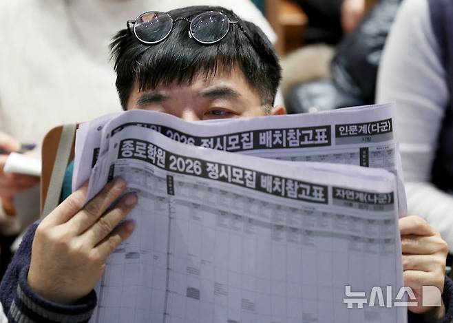 [서울=뉴시스] 김진아 기자 = 7일 서울 종로구 성균관대학교 600주년 기념관에서 열린 종로학원 주최 2026 정시 합격 가능선 예측 및 지원전략 설명회에서 참석자들이 배치표를 살펴보고 있다. 2025.12.07. bluesoda@newsis.com