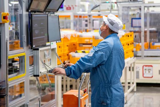 An employee inspects the battery production process at LG Energy Solution’s plant in Holland, Michigan. [LG]