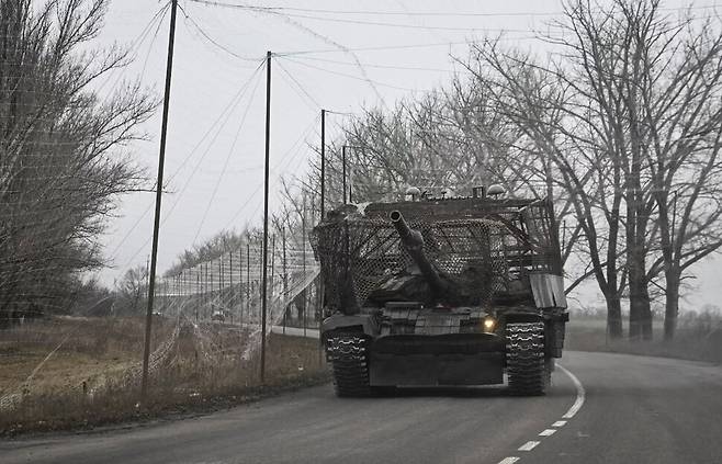 지난해 11월20잂 우크라이나 도네츠크의 전선 도시 포크로우스크. 드론 방어 그물로 덮은 장갑차가 드론 방어 그물로 뒤덮힌 도로를 달리고 있다. 로이터 연합뉴스