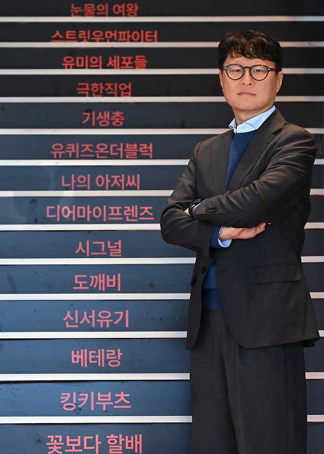 Yea Ju-yeol, head of CJ ENM's Performing Arts Division, poses in front of a staircase displaying the company’s hit projects at the CJ ENM Center in Sangam-dong, Mapo-gu, Seoul, on Dec. 3. (Lee Sang-sub/The Korea Herald)