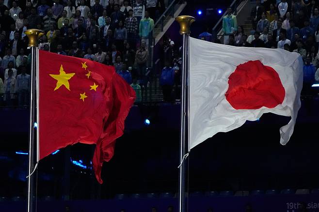 The flags of China and Japan are flown during the handover ceremony from China to Japan, the next host of the Asian Games, at the closing ceremony of the 19th Asian Games in Hangzhou, China, on Oct. 8, 2023. (File Photo - AP)