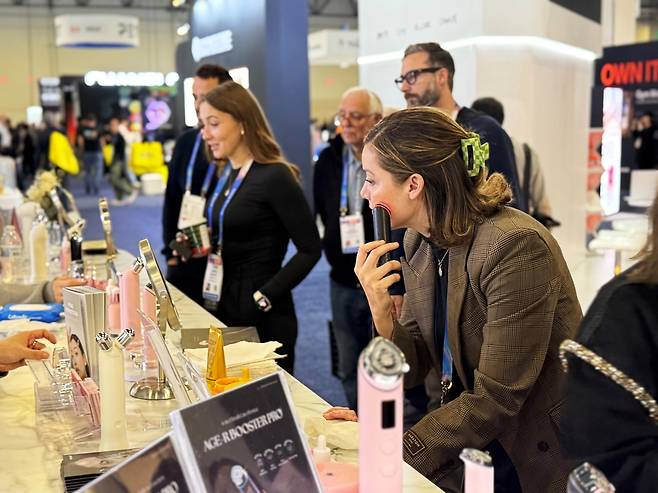 에이피알의 CES 부스를 찾은 방문객이 메디큐브 에이지알 뷰티 디바이스를 체험하고 있는 모습. 에이피알 제공