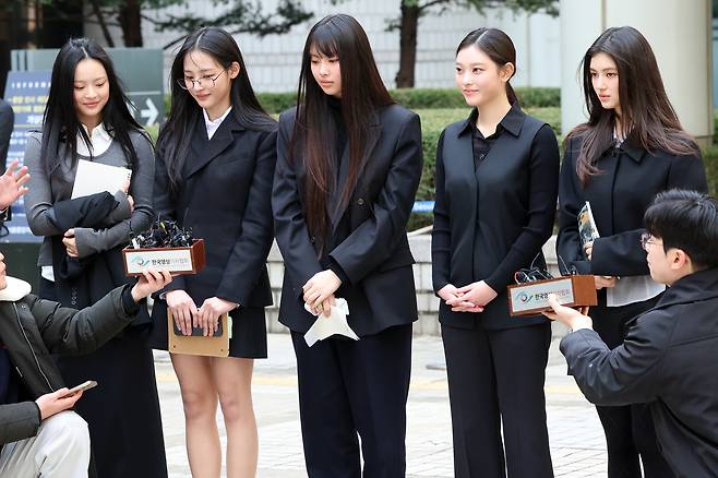 Members of girl group NewJeans answer questions from reporters after attending a court hearing at the Seoul Central District Court in southern Seoul on March 7, 2025. [NEWS1]