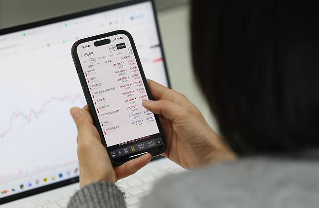 최근 서울 중구 한 사무실에서 직장인이 스마트폰으로 미국 증시 주요 종목들을 살펴보는 모습. /박성원 기자