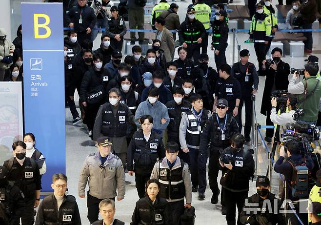 [인천공항=뉴시스] 김진아 기자 = 한국 국적 캄보디아 스캠조직 피의자들이 23일 오전 인천국제공항 제2터미널을 통해 강제 송환되고 있다.  초국가범죄 특별대응 TF는 캄보디아를 거점으로 우리 국민 869명에게 약 486억원을 편취한 한국 국적 피의자 73명을 강제 송환했다. 2026.01.23. bluesoda@newsis.com
