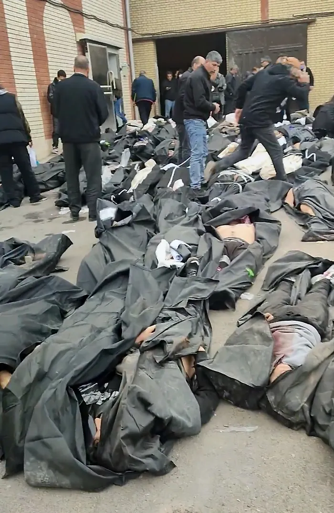 지난 1월 9~11일(현지시간) 촬영돼 소셜미디어에 유포된 영상에서 캡처한 이 화면. 테헤란 외곽 카흐리자크에서 벌어진 당국의 강경 진압 이후 시신 수십 구와 조문객들이 모여 있는 영안실 내부를 보여분다. AP연합뉴스