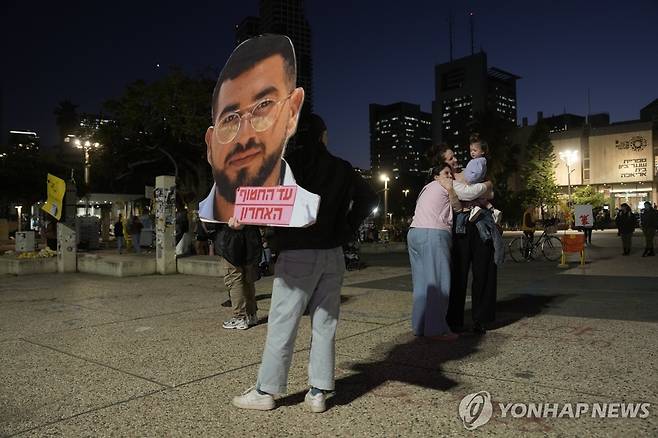 란 그빌리 사진 들고 그빌리 시신 반환을 환영하는 이스라엘인 [AFP 연합뉴스. 재판매 및 DB 금지]
