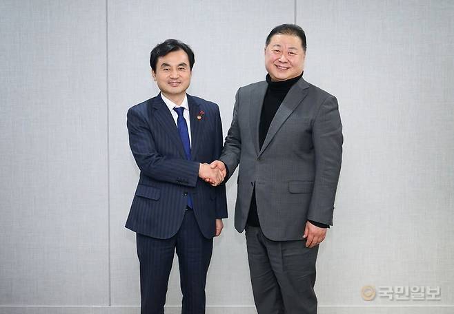 김경일(오른쪽) 파주시장이 지난 28일 국방부에서 열린 ‘경기북부 미군공여구역 간담회’에서 안규백 국방부 장관에게 반환공여구역 관련 건의사항을 전달하고 기념촬영을 하고있다. 파주시 제공