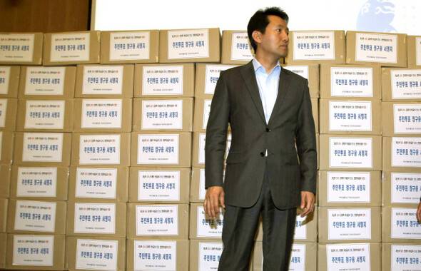 오세훈 서울시장이 2011년 6월 ‘전면 무상급식’ 반대 주민투표를 청구하는 서명지가 담긴 상자 앞에 서 있다. 한겨레 자료사진