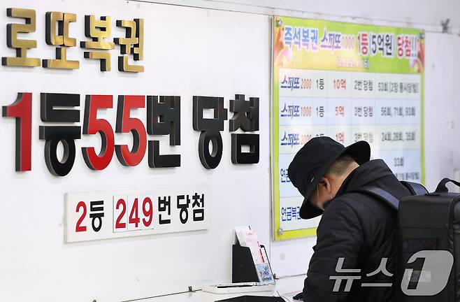 서울 노원구에 위치한 복권 판매점을 찾은 시민이 복권을 구매하고 있다. ⓒ News1 장수영 기자