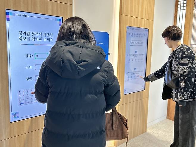 ▲ 경북 의성군 단밀면 의성농촌효테마공원 2층 효리스페이스에서 6일, 관람객들이 기획전 '공경'의 체험형 콘텐츠인 효BTI 키오스크를 이용해 효 성향 설문에 참여하고 있다. 의성문화사