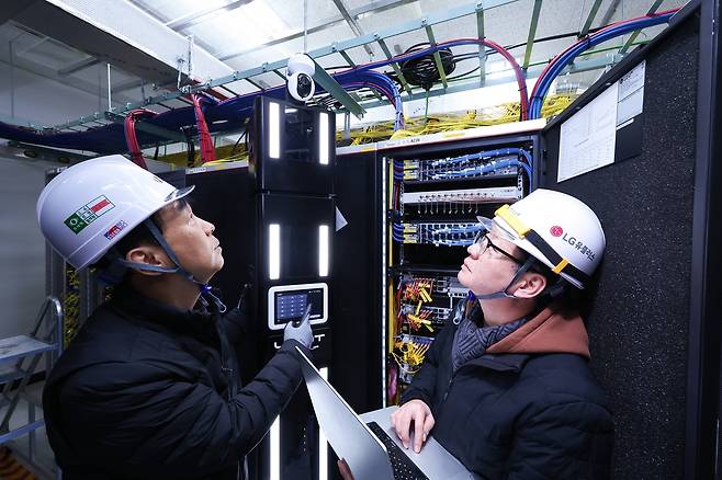 LG유플러스 직원이 AI 자율주행 로봇 ‘유-봇(U-BOT)’을 소개하고 있다. [LG유플러스 제공]