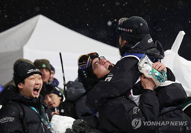 금이래요 (리비뇨=연합뉴스) 신준희 기자 = 12일(현지시간) 이탈리아 리비뇨 스노파크에서 열린 2026 밀라노-코르티나담페초 동계올림픽 스노보드 여자 하프파이프 결승에서 최가온이 금메달을 확정짓고 팀 관계자들과 기뻐하고 있다. 2026.2.13 hama@yna.co.kr