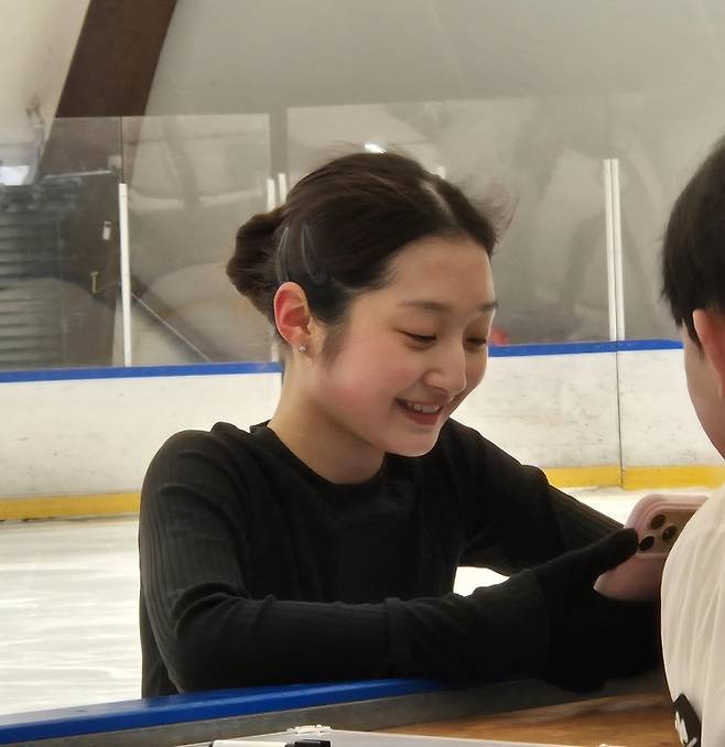 피겨 스케이팅 여자 싱글 신지아가 이탈리아 밀라노 아이스스케이팅 아카데미 링크장에서 개인 훈련 도중 자신의 훈련 영상을 보며 미소 짓고 있다. 사진 | 연합뉴스