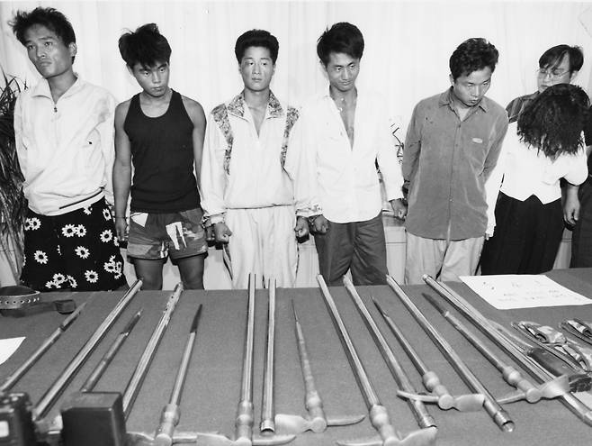 Six Chijon Family gang members are photographed in front of their weapons in September 1994. [JOONGANG ILBO]