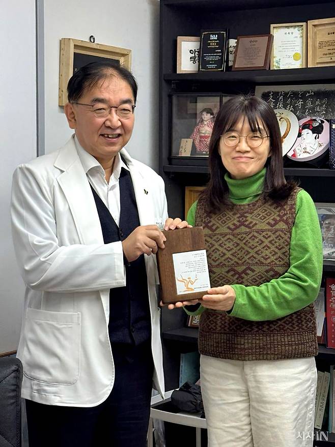 ‘먹고사는 일’ 연재는 전태일의료센터 건립의 마중물을 만들고자 시작했다. 1월20일 임상혁 녹색병원장이 은유 작가에게 감사패를 전달하고 있다. ⓒ시사IN 장일호