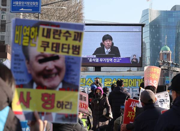 촛불행동 관계자들이 19일 서울중앙지법 인근에서 12·3 비상계엄과 관련해 내란 우두머리 혐의로 기소된&nbsp;윤석열&nbsp;전 대통령에 대한 1심 선고 생중계를 시청하고 있다. 이날 재판부는 윤 전 대통령에게 무기징역을 선고했다. 2026.2.19 연합뉴스