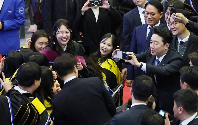 강훈식 비서실장이 20일 대전 유성구 한국과학기술원(KAIST)에서 열린 학위수여식에서 이재명 대통령과 졸업생들의 기념사진을 찍어주고 있다. 연합뉴스