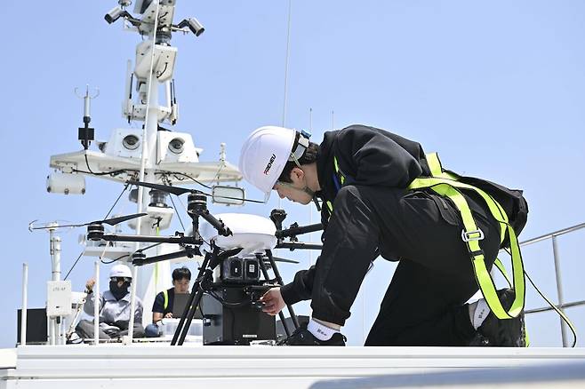 울산 일산항 인근 해상에서 지난해 5월 진행된 해군 주관 전·평시 상용 무인체계 작전 운용 가능성 검증훈련에 참가한 드론 운용 민간 요원이 선박해양플랜트연구소 해양누리호 갑판에서 드론&nbsp;이륙을 준비하고 있다. 해군 제공