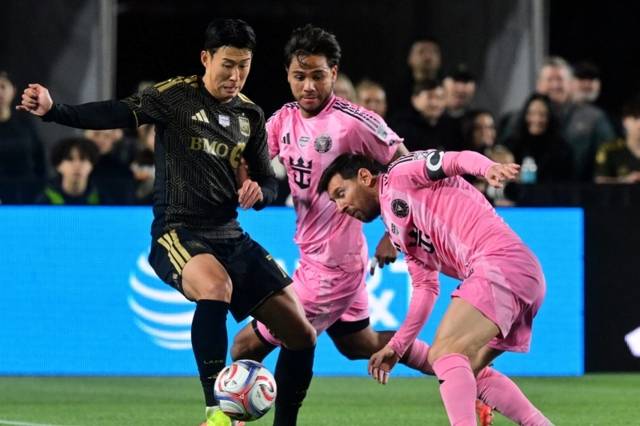 ▲ 로스앤젤레스 FC 손흥민(왼쪽)이 22일(한국 시간) 미국 LA 메모리얼 콜리세움에서 열린 인터 마이애미 CF와 2026 메이저 리그 사커 개막전에서 리오넬 메시의 수비를 벗겨내고 있다. AFP/연합뉴스