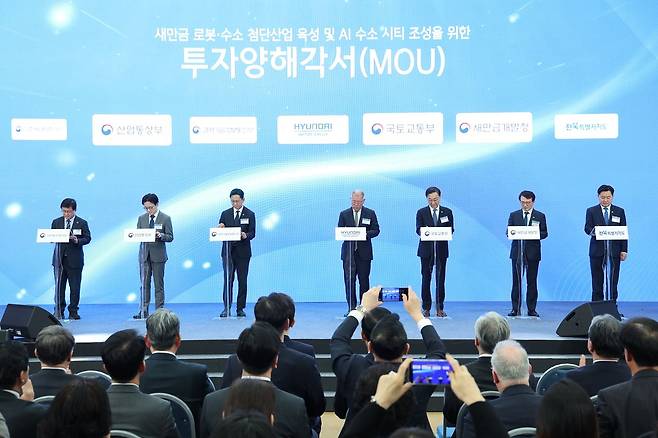 김성환 기후에너지환경부 장관(왼쪽부터), 김정관 산업부 장관, 배경훈 부총리 겸 과기부 장관, 정의선 현대차그룹 회장, 김윤덕 국토부 장관, 김의겸 새만금개발청장, 김관영 전북도지사가 27일 전북 군산새만금컨벤션센터에서 열린 새만금 로봇·수소·AI 시티 투자협약식에서 투자양해각서에 서명하고 있다. 연합뉴스