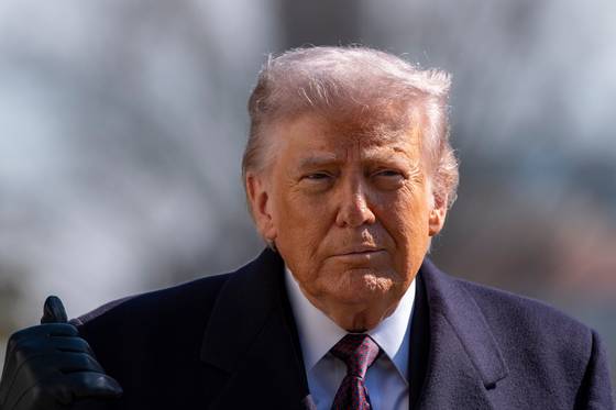 U.S. President Donald Trump walks to speak with reporters before departing on Marine One from the White House in Washington on Feb. 27. [AP]