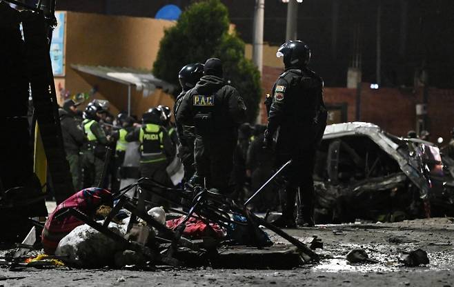 27일(현지시간) 볼리비아 수도 라파스 인근 엘알토 국제공항 근처에서 군 수송기가 추락한 가운데 사고 현장인 도로에 경찰과 구조대원이 모여 있다. 2026.2.27 로이터 연합뉴스