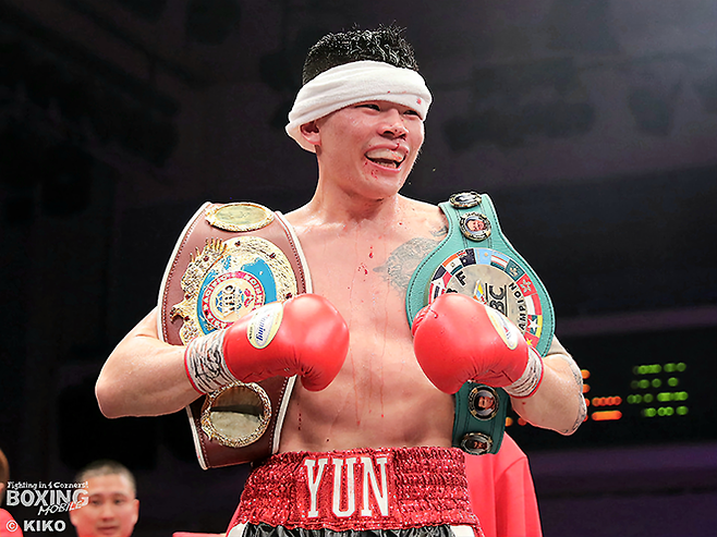 윤덕노가 2025년 12월 일본 도쿄 고라쿠엔홀에서 슈퍼미들급 통합 타이틀 방어 기념 촬영을 하고 있다. 왼쪽은 세계복싱기구 아시아태평양, 오른쪽은 동양태평양복싱연맹 챔피언 벨트. 사진=ボクシングモバイル(boxmob.jp) 제공