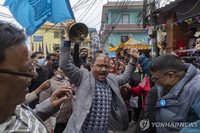 네팔 총선 중도 신생정당 압승 전망 (카트만두 EPA=연합뉴스) 6일(현지시간) 네팔 수도 카트만두에서 중도 국민독립당(RSP) 소속 후보와 지지자들이 하늘색 당 깃발과 당의 상징인 종을 흔들면서 총선 승리를 자축하고 있다.
