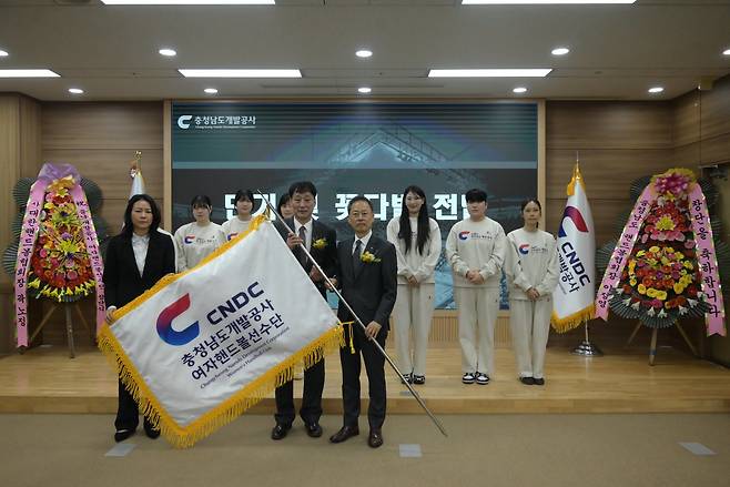 김병근 충남개발공사 사장, 강재원 감독, 김차연 코치(앞 오른쪽부터)가 10일 충남 홍성군 공사 대회의실서 열린 여자핸드볼구단 창단식서 구단기를 들고 창단을 기념하고 있다. 사진제공│충남개발공사