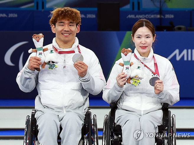 '자랑스러운 은메달' (코르티나담페초=연합뉴스) 한종찬 기자 = 11일(현지시간) 이탈리아 코르티나 컬링 올림픽 스타디움에서 열린 2026 밀라노·코르티나담페초 동계 패럴림픽 휠체어컬링 믹스더블 시상식에서 은메달을 차지한 이용석과 백혜진이 포즈를 취하고 있다. 2026.3.12 saba@yna.co.kr