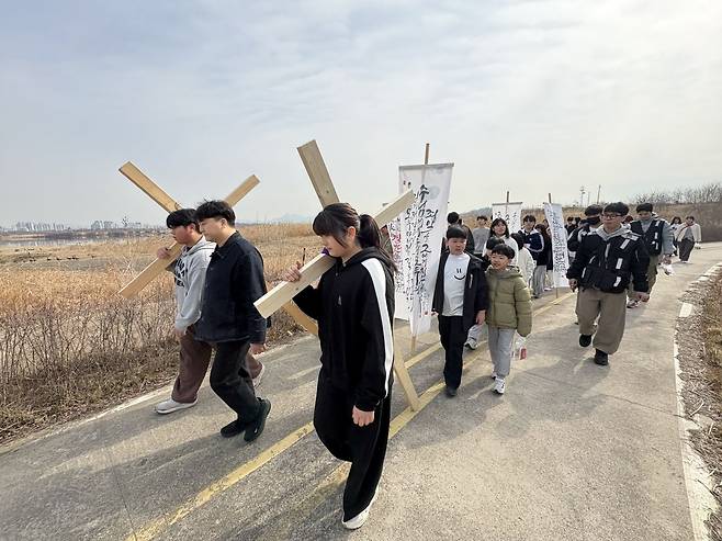 제3회 크로스로드에 참여한 다음세대들이 14일 경기도 김포 일대에서 십자가를 지고 걷고 있다.