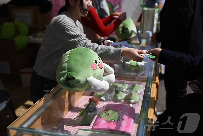 15일 광양매화축제장을 찾은 관광객이 매돌이 굿즈를 구매하고 있다. ⓒ 뉴스1 김성준 기자