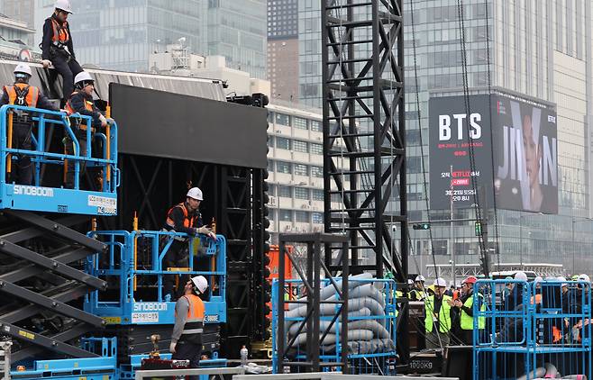 Workers set up a stage for BTS’ comeback concert at Gwanghwamun Square in Seoul on Monday. (Yonhap)
