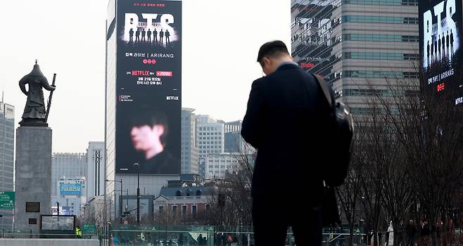 An advertisement for the Netflix live streaming of BTS’s upcoming “Arirang” comeback performance is displayed on a billboard near Gwanghwamun Square in Jongno District, central Seoul, on March 11. [NEWS1]