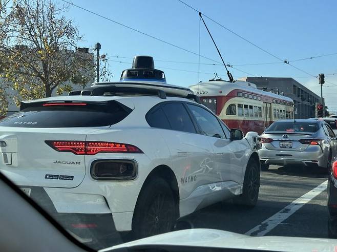 구글 웨이모 로보택시가 샌프란시스코의 관광명소인 피어39 주변에서 일반 차량, 트램과 함께 주행하고 있다. 사진=백종민 테크 스페셜리스트