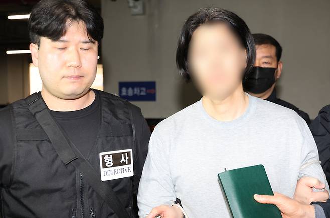 항공사 기장을 흉기로 살해한 50대 김모 씨가 20일 부산 부산진경찰서에서 구속 전 피의자 심문(영장실질심사)에 출석하기 위해 이동하고 있다.[연합뉴스]