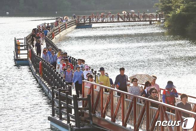 17일 오후 경북 구미시 금오산 금오지에서 열린 '구미공단 50주년 올레길 건강체험행사'에 참여한 시민들이 호수위로 설치된 산책길을 걷고 있다.2019.9.17 ⓒ 뉴스1 정우용 기자