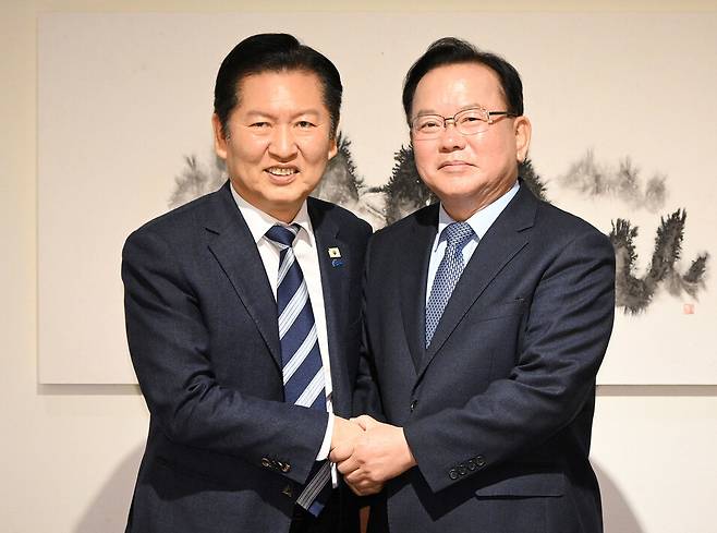 정청래 더불어민주당 대표와 김부겸 전 국무총리가 지난 26일 서울 중구 달개비에서 회동 전 손을 맞잡고 있다. 국회사진기자단