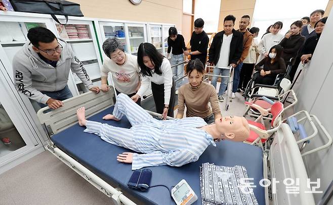 25일 경기 양주시 서정대에서 베트남, 스리랑카 등 7개국에서 온 유학생들이 마네킹을 이용해 노인을 침대에 눕혀 보는 실습을 하고 있다. 이들은 정부가 시행하는 ‘외국인 요양보호사 양성 대학 시범사업’을 통해 노인돌봄 인력으로 육성될 예정이다. 양주=전영한 기자 scoopjyh@donga.com