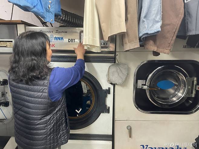 30일 오전 서울 마포구에서 세탁소를 운영하는 이기숙씨(58)가 세탁물을 살피는 모습. 최근 드라이클리닝에 필요한 기름값은 2배 넘게 올랐다./사진=이현수 기자.